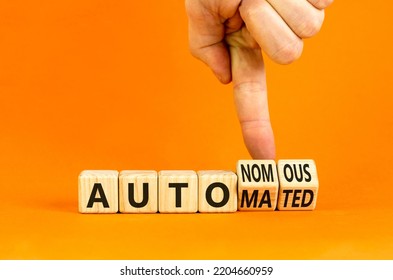 Autonomous Or Automated Vehicle Symbol. Businessman Turns Cubes And Changes Words Autonomous To Automated. Orange Background. Business Technology Autonomous Or Automated Vehicle Concept. Copy Space.