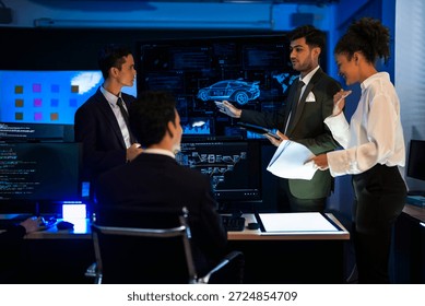 Autonomous driving software developers discussing car AI navigation system. IT specialist explaining self-driving vehicle simulation data to colleagues in modern control room.
