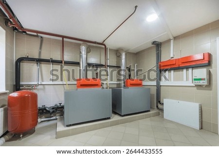 Autonomous heating system in the basement of a private house. Special modern equipment in the boiler room interior.