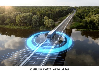 Autonomous semi-truck with a trailer, controlled by artificial intelligence, drives over a bridge over the river. Cargo delivery, transportation of the future. Artificial intelligence. Self driving.
 - Shutterstock ID 2342416523