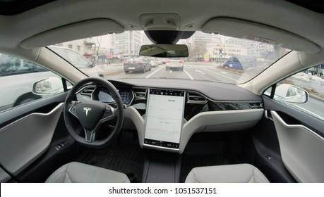 AUTONOMOUS TESLA CAR, FEBRUARY 2016: Fully Autonomous Self-driving Autopilot Tesla Model S Driverless Car Maneuvering On Local Street In Urban City. Enhanced Next Gen Intelligent Robotic Vehicle