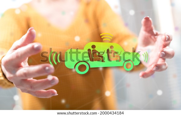 Autonomous vehicle concept between hands of a\
woman in background