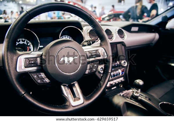 AUTOSHOW PRAHA, CZE - SEPT 24: Ford mustang running\
horse logo design on GT model steering wheel - car interior detail\
- on display at motorcar exhibition in Prague, Czech Republic in\
September 2016