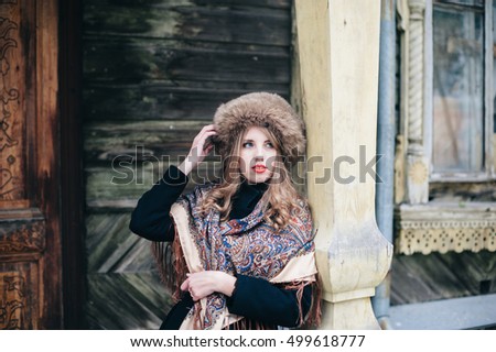 Similar – Portrait of smiling blonde woman with hat while she walks in nature looking into camera.