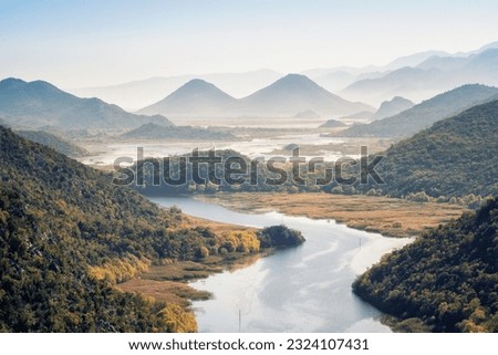 Autumn aerial view of Lake Skodar with its picturesque shores and misty hills in the distance, Montenegro.