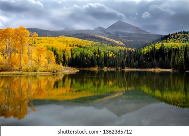 Autumn afternoon at Woods Lake near Telluride Colorado with Wilson Peak and changing yellow aspen trees reflecting in lake