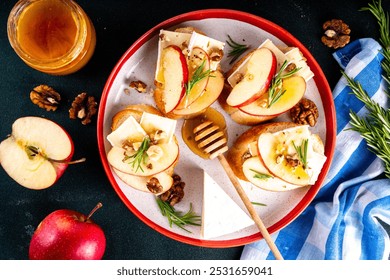 Autumn Apple Brie Crostini with Walnuts and Honey, Fall dinner, Thanksgiving party appetizers idea. Small sandwiches with red apple slices, brie cheese and sweet honey drizzles - Powered by Shutterstock