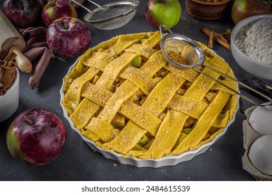 Autumn apple pie cooking background. Baking background with raw traditional classic apple pie, baking ingredients and utensils, black concrete background copy space  - Powered by Shutterstock