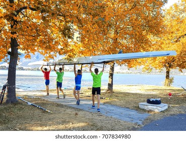 autumn athletes team carrying their boat in the lake Pamvotis of Ioannina Greece  - Powered by Shutterstock