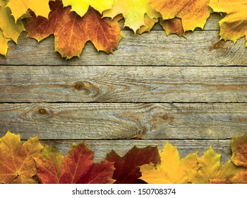 autumn background with colored leaves on wooden board - Powered by Shutterstock