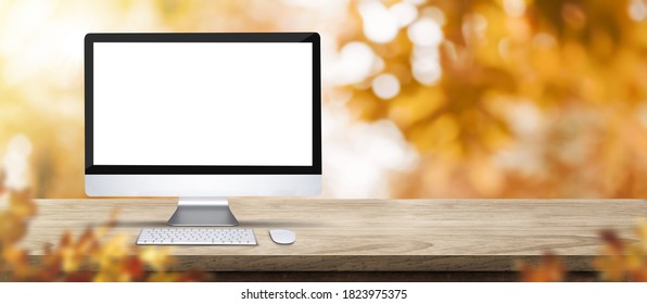 Autumn Background. Desktop Computer On Rustic Wood Table With Blur Forest Tree With Sunlight,Autumn Fall Backdrop, Banner For Product Display For Advertise On Online,thanksgiving Concept 3d Rendering