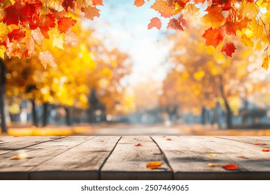 Autumn background with empty wooden table, red and yellow leaves and blurred background