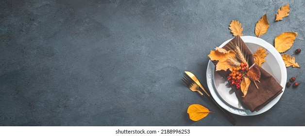 Autumn background with a plate with cutlery on a graphite background. The concept of Halloween, Thanksgiving. Top view, copy space - Shutterstock ID 2188996253