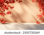 
Autumn background scene with red maple leaves on table with sunlight. Natural seasonal home decor for fall season, thanksgiving and holiday showroom.