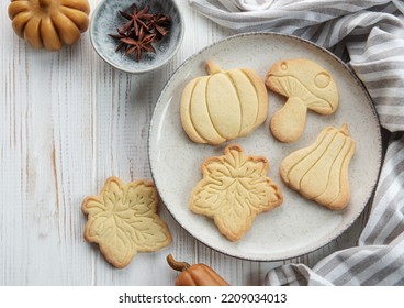 Autumn baking. Cookies in the form of pumpkin and leaves on the table. Cozy autumn concept. - Powered by Shutterstock