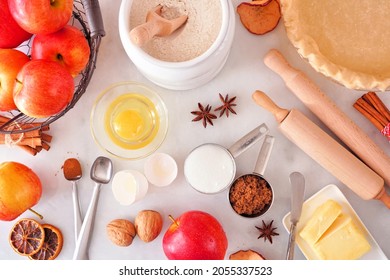 Autumn Baking Table Scene With Apple Pie Ingredients. Top Down View Over A White Marble Background.