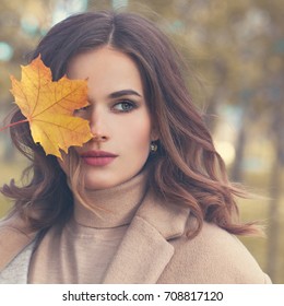 Autumn Beauty. Perfect Woman Fashion Model With Fall Maple Leaf Outdoors