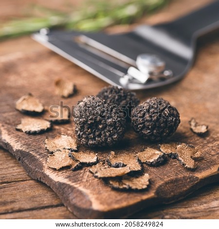Autumn black truffles mushrooms and truffles knife on rustic wooden table, square crop, selective focus Foto d'archivio © 