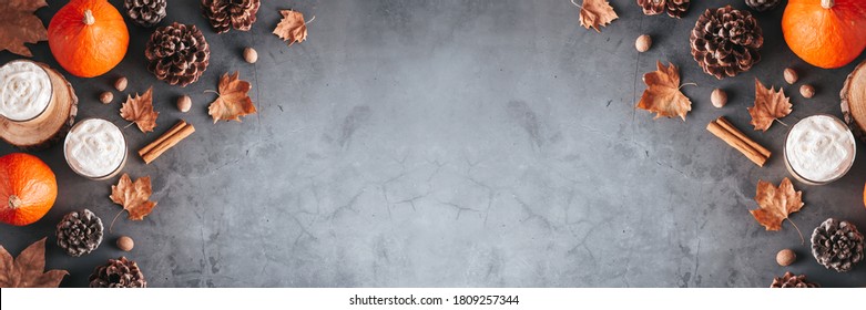 Autumn border banner with natural pine cones, pumpkins, dried leaves and pumpkin latte on dark grey stone top, top view, copy space. Fall, Thanksgiving background web banner, cozy flat lay - Powered by Shutterstock