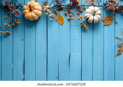 Autumn Border with Pumpkins and Berries on Blue Wooden Background - Powered by Shutterstock