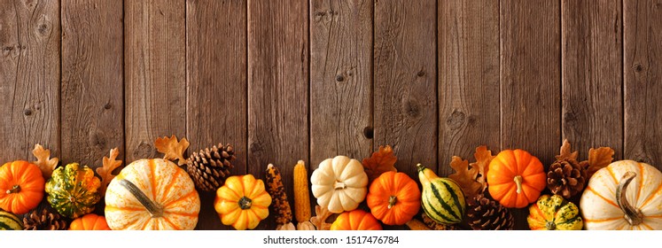 Autumn bottom border banner of pumpkins, gourds and fall decor on a rustic wood background with copy space - Powered by Shutterstock