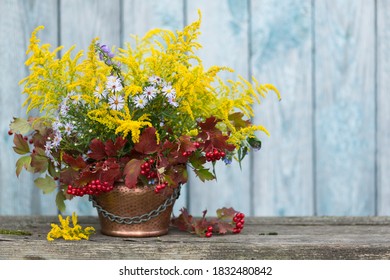 Autumn Bouquet Of Flowers With Viburnum Berries In A Copper Planter Outdoors