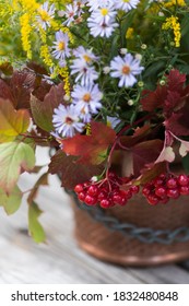 Autumn Bouquet Of Flowers With Viburnum Berries In A Copper Planter Outdoors