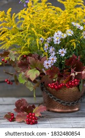 Autumn Bouquet Of Flowers With Viburnum Berries In A Copper Planter Outdoors