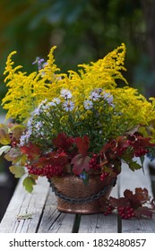 Autumn Bouquet Of Flowers With Viburnum Berries In A Copper Planter Outdoors