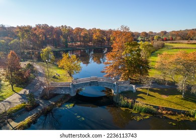 An autumn bridge over a pond - Shutterstock ID 2236113743