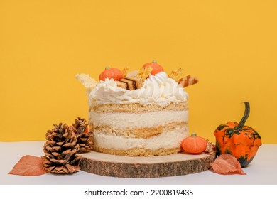 Autumn Cake With Pumpkins Staying On The Wood On Yellow Background, Thanksgiving Cooking