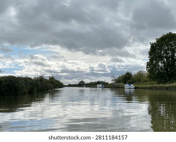 Autumn Canal With Dramatic Cloudy Sky And Water Reflections In Gloucestershire England