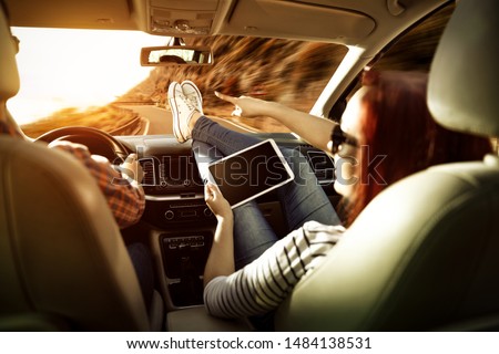 Similar – young women enjoying vacation in the car on road trip