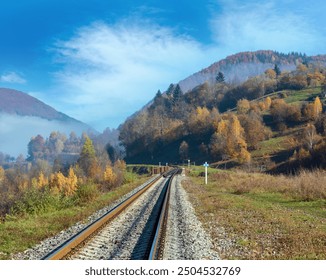 Autumn Carpathian Mountains misty landscape with  railroad bridge and village outskirts (Rakhiv district, Transcarpathia, Ukraine). - Powered by Shutterstock