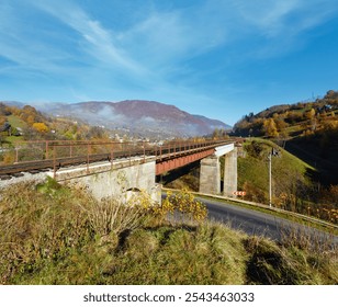 Autumn Carpathian Mountains misty landscape with  railroad bridge and village outskirts (Rakhiv district, Transcarpathia, Ukraine). - Powered by Shutterstock