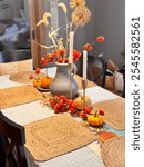 Autumn centerpiece with dried tomatoes and miniture pumpkins