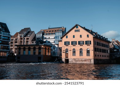 Autumn charm in Strasbourg, France, featuring picturesque riverside architecture in vibrant colors under a clear blue sky - Powered by Shutterstock