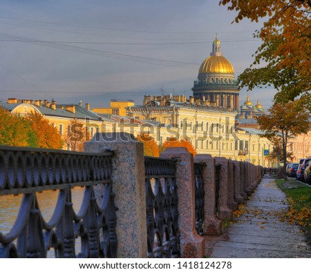 Autumn cityscape with the embankment of the Moika river and St. Isaac's Cathedral in Saint-Petersburg