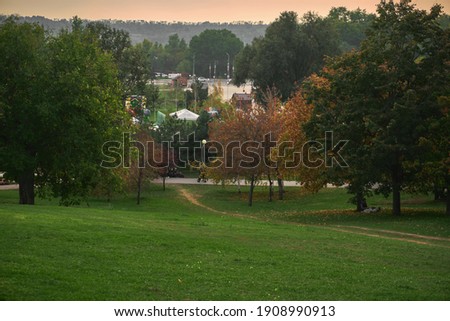 autumn cityscape  green park with beautiful trees and grass
