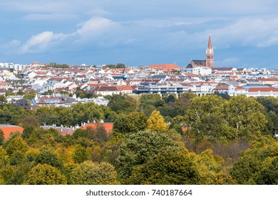 The autumn colours show in the tree canopy with the suburban cityscape of Vienna in the background.