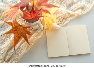 Autumn Composition. Blank Calendar, Notebook Mockup Over White Background. Colourful Dry Leaves. Autumn, Fall, Halloween Concept. Daylight At Sunset