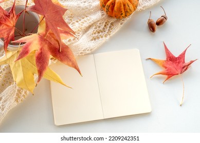 Autumn Composition. Blank Calendar, Notebook Mockup Over White Background. Pumpkins, Dry Leaves, Acorns. Autumn, Fall, Halloween Concept. Daylight At Sunset