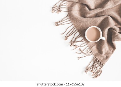 Autumn composition. Cup of coffee, plaid on white background. Autumn, fall concept. Flat lay, top view, copy space