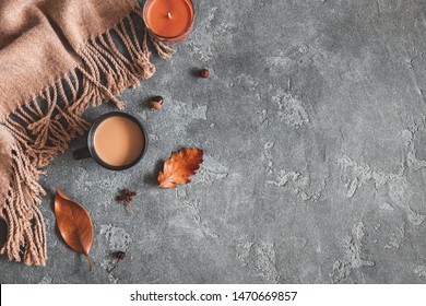 Autumn composition. Cup of coffee, plaid, autumn leaves on black background. Flat lay, top view, copy space