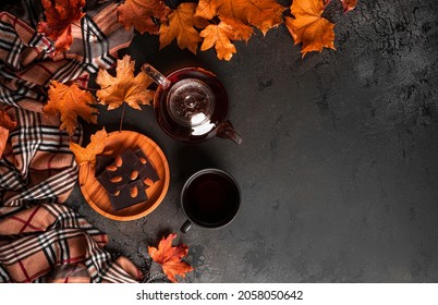 Autumn Composition. A Cup Of Tea And Teapot, Scarf, Autumn Leaves. Flat Lay, Top View, Copy Space. High Quality Photo