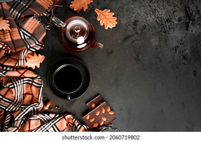 Autumn Composition. A Cup Of Tea And Teapot, Scarf, Autumn Leaves. Flat Lay, Top View, Copy Space. High Quality Photo