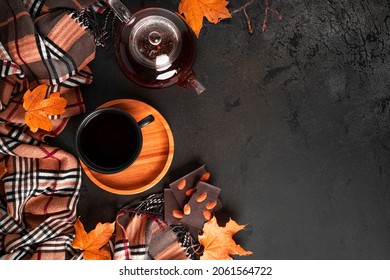 Autumn Composition. A Cup Of Tea And Teapot, Scarf, Autumn Leaves. Flat Lay, Top View, Copy Space. High Quality Photo