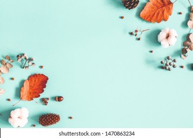 Autumn composition. Dried leaves, cotton flowers on pastel blue background. Autumn, fall, winter concept. Flat lay, top view, copy space