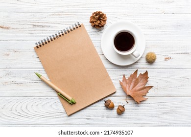 Autumn composition: fallen leaves and craft sketchbook mock up on colored background. Top view. Flat lay with copy space. - Shutterstock ID 2174935107
