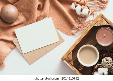 Autumn Composition. Feminine Desk Table With Letter, Blank Paper Card, Brown Scarf, Cotton On White Background. Flat Lay, Top View. Nordic, Hygge, Cozy Home Concept